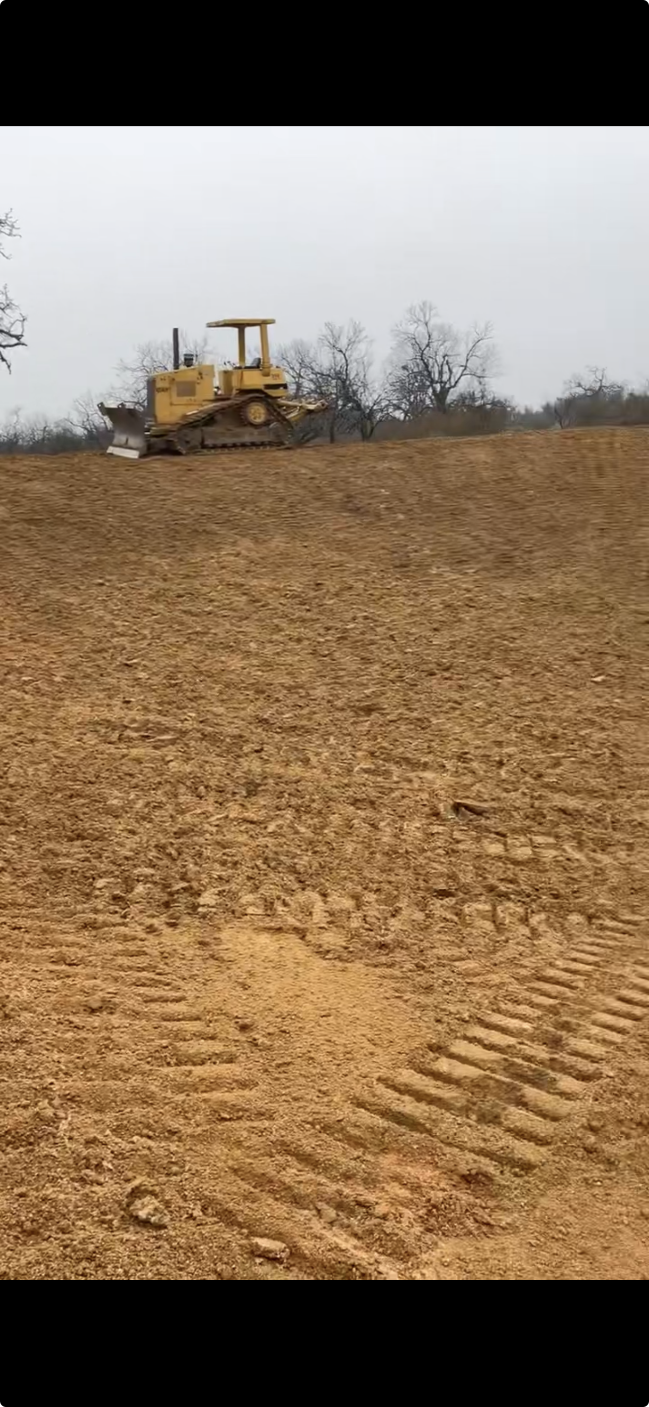Bulldozer and truck on a freshly cleared Texas ranch site